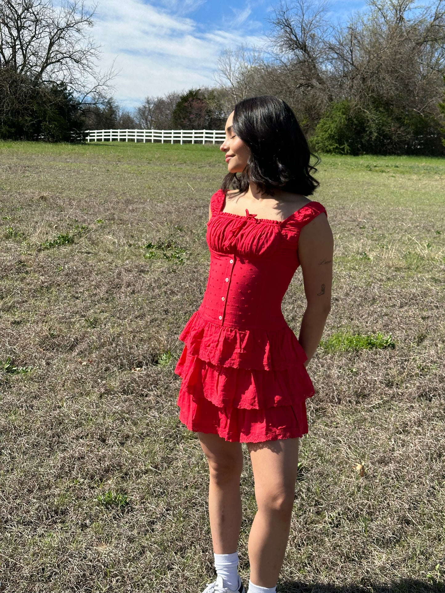 red drop waist mini dress with buttons and ruffles at bottom