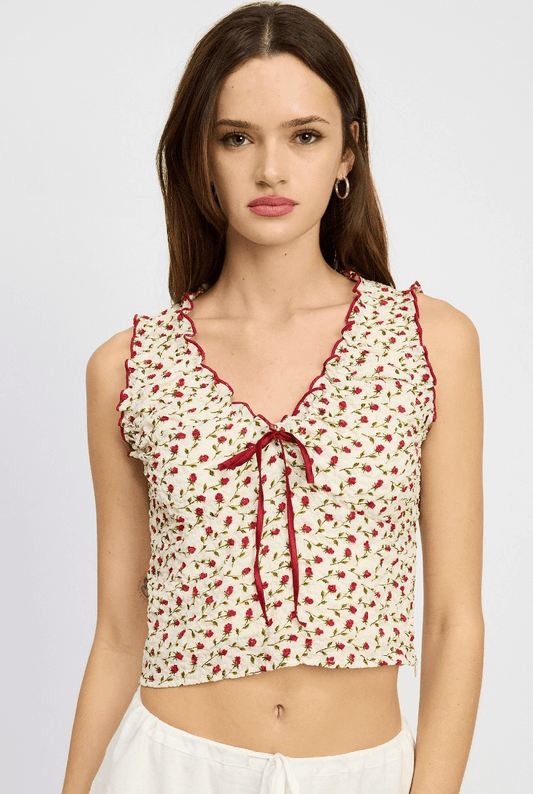 red floral blouse with red trim details and ruched pattern.