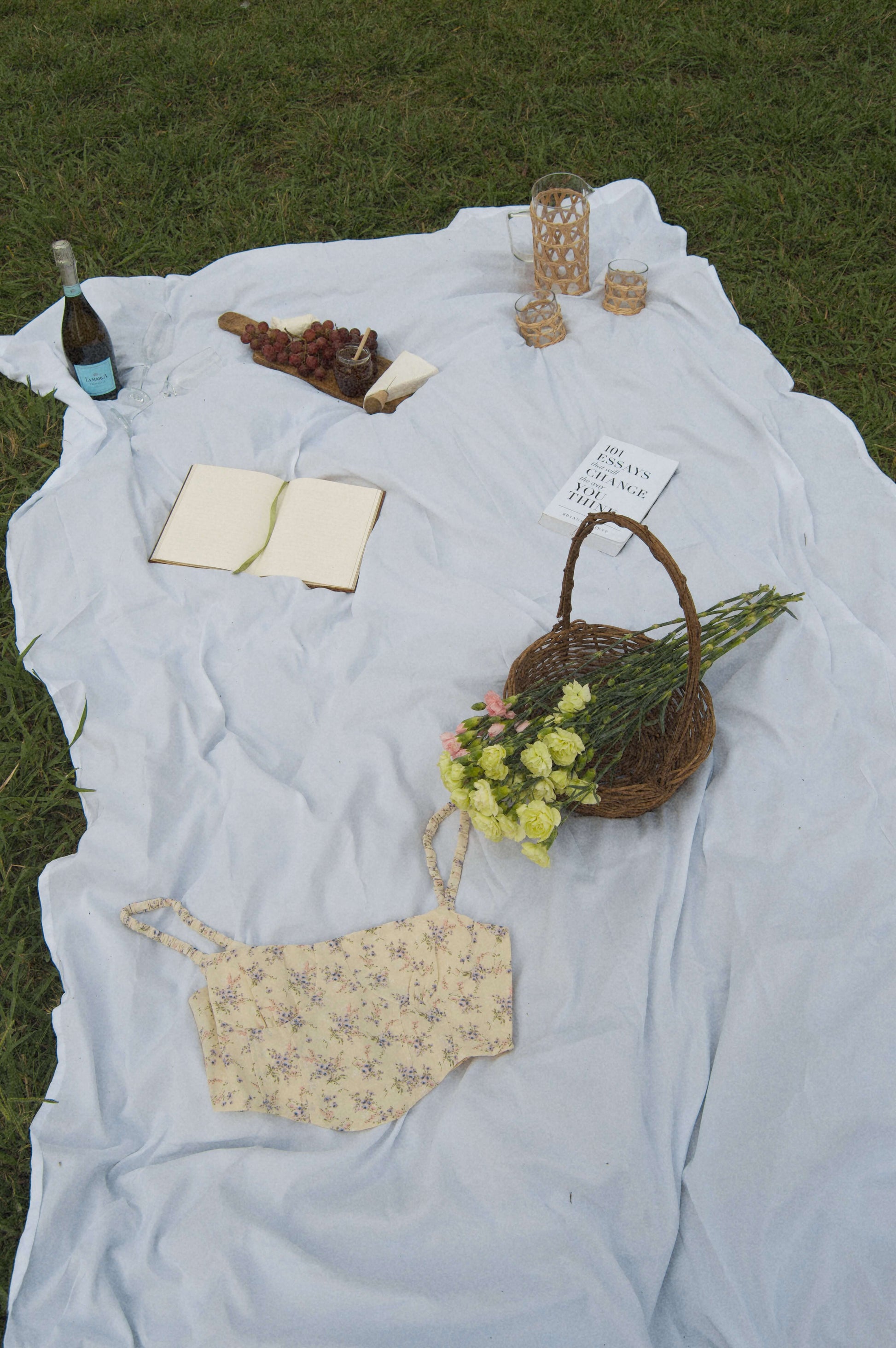 lavender floral corset top in a flat lay against a picnic background.