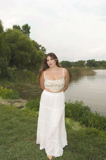 lavender floral corset top on model doing a picnic in front of a lake.