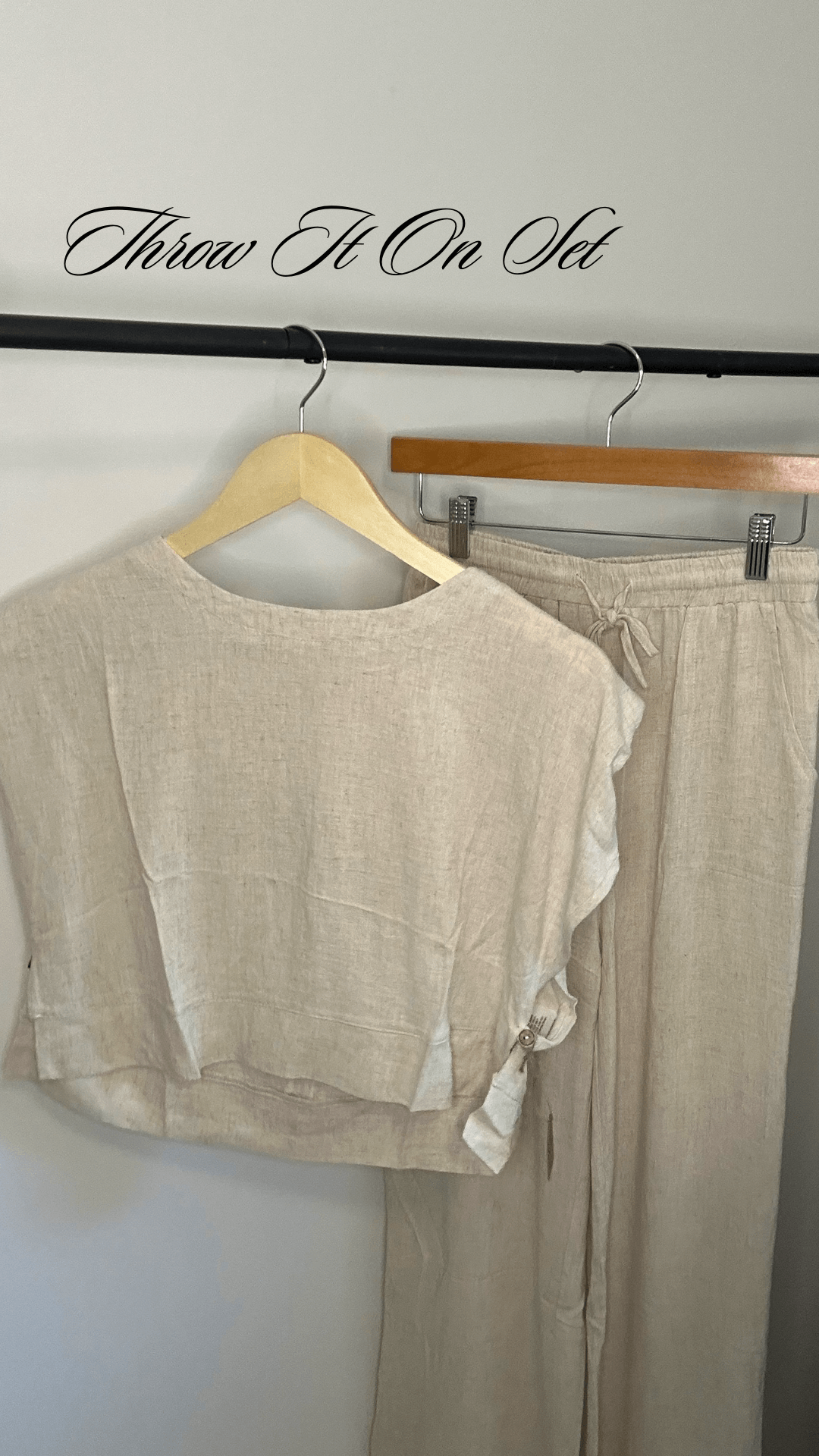 linen two piece set with muscle tee style top including shoulder pads and high waisted flowy linen pants on hanger